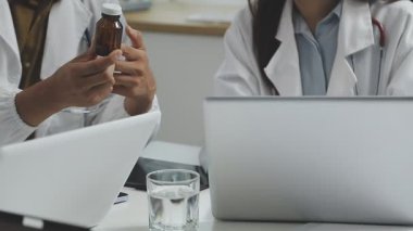 Manzarayı kapat. Doktorlar bir hastayı tabletle tartışıyor.