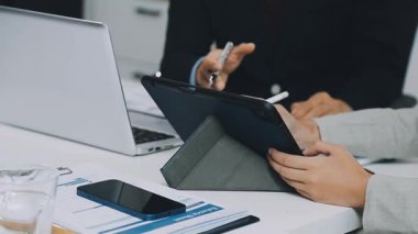 İş yerinde bilgisayar ve tablet kullanan iş adamı ve kadın