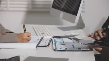 Ofiste belgelerle çalışan genç bir iş adamı.