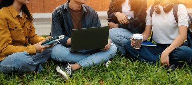 Üniversite kampüsünde birlikte yürüyen mutlu öğrenciler, derslerden sonra dışarıda sohbet edip gülüyorlar.