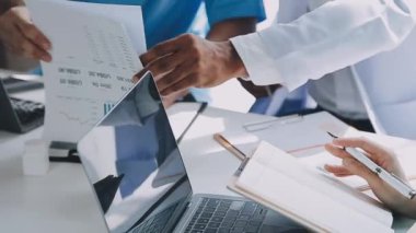 Bir grup tıp doktoru röntgen sonuçlarını tartışıyor ve analiz ediyor.