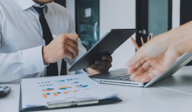 Close up of Business team analyzing income charts and graphs with modern laptop computer. Business analysis and strategy concept.