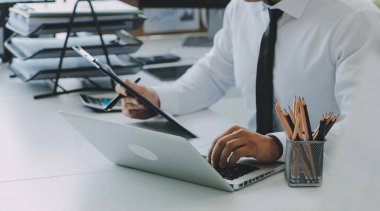 Close up of Business team analyzing income charts and graphs with modern laptop computer. Business analysis and strategy concept.