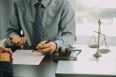Adalet ve hukuk kavramı. Hukuk Müşaviri tokmak ve yasal hukuk veya yasal ile imzalanmış bir sözleşme istemciye sunar arka planda hukuk firmasında takım toplantısı