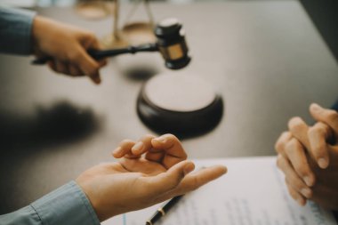 Adalet ve hukuk kavramı. Hukuk Müşaviri tokmak ve yasal hukuk veya yasal ile imzalanmış bir sözleşme istemciye sunar arka planda hukuk firmasında takım toplantısı