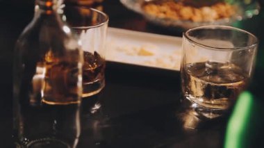 Tahta masadaki buzlu bir bardak viski.