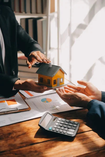 Real estate agent and customer signing contract to buy house, insurance or loan real estate.rent a house,get insurance or loan real estate or property.