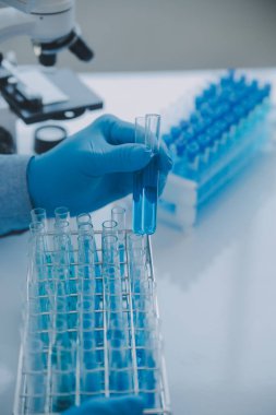 Coronavirus aşısı geliştirmek için mikroskop ile çalışan biyokimyasal araştırma ekibi farmasötik araştırma laboratuvarında, seçici odaklı