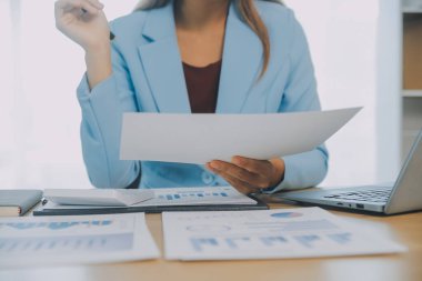 İş ekibi ile yeni başlangıç planı ve tartışma için proje bilgilerini dizüstü bilgisayar ve dijital tablet ile mali strateji bir modern iş salonda çalışıyor.