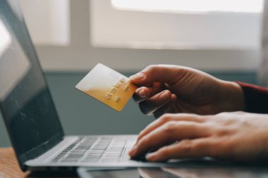 Close up of woman hand using credit card and laptop for payment and online shopping, Online shopping, payments digital banking, E-commerce concept.