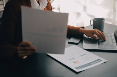 Genç Asyalı kadın portresi modern ofiste bilgisayar tableti üzerinde çalışıyor. Muhasebe analizi yapmak gayrimenkul yatırım verileri, mali ve vergi sistemleri kavramı.