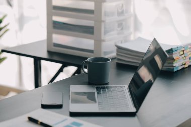 Bir ofis masası, vergi, rapor, muhasebe, istatistik ve analitik araştırma kavramında matematik finansmanı için hesap makinesi ve dizüstü bilgisayar kullanan Asyalı İş kadını
