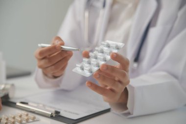 Healthcare service and pharmacy worker with customer at store counter for medication explanation. Pharmaceutical advice and opinion of pharmacist helping girl with medicine information.