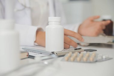 Healthcare service and pharmacy worker with customer at store counter for medication explanation. Pharmaceutical advice and opinion of pharmacist helping girl with medicine information.