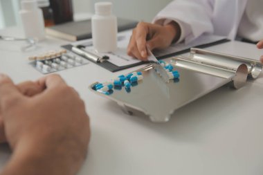 Healthcare service and pharmacy worker with customer at store counter for medication explanation. Pharmaceutical advice and opinion of pharmacist helping girl with medicine information.