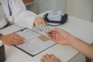 Healthcare service and pharmacy worker with customer at store counter for medication explanation. Pharmaceutical advice and opinion of pharmacist helping girl with medicine information.