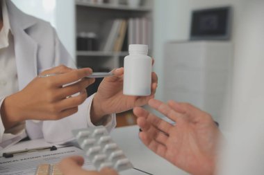 Healthcare service and pharmacy worker with customer at store counter for medication explanation. Pharmaceutical advice and opinion of pharmacist helping girl with medicine information.