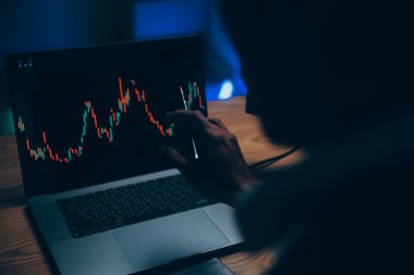 Thoughtful focused successful caucasian male stock investor, broker, financial adviser, sits at work desk, looks at computer, pensively analyze risks and prospects, rise or fall of cryptocurrency coin