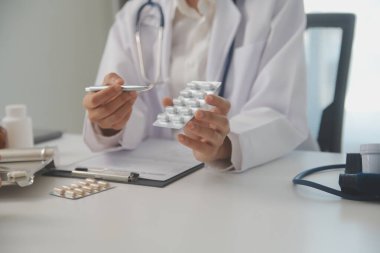 Healthcare service and pharmacy worker with customer at store counter for medication explanation. Pharmaceutical advice and opinion of pharmacist helping girl with medicine information.