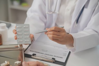 Healthcare service and pharmacy worker with customer at store counter for medication explanation. Pharmaceutical advice and opinion of pharmacist helping girl with medicine information.