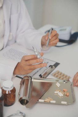 Healthcare service and pharmacy worker with customer at store counter for medication explanation. Pharmaceutical advice and opinion of pharmacist helping girl with medicine information.