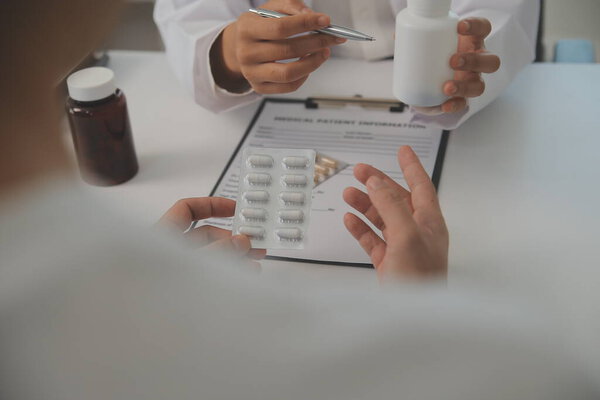 Healthcare service and pharmacy worker with customer at store counter for medication explanation. Pharmaceutical advice and opinion of pharmacist helping girl with medicine information.