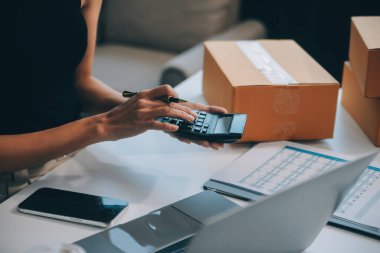 İş kadını küçük işletmelere başladı ve başarılı KOBİ girişimcileri Asyalı kadın kutuları evdeki paketlerin çevrimiçi teslimatını yapıyor. KOBİ dağıtım kavramı ve ambalaj
