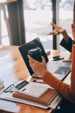 Başarılı iş grubu, toplantıda birlikte dijital tablet kutluyor ve arıyor. İnsanlar silah larını kaldırıyor..