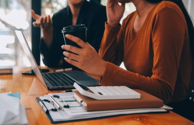 Başarılı iş grubu, toplantıda birlikte dijital tablet kutluyor ve arıyor. İnsanlar silah larını kaldırıyor..