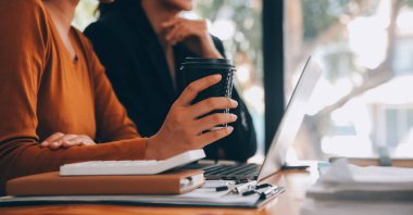 Başarılı iş grubu, toplantıda birlikte dijital tablet kutluyor ve arıyor. İnsanlar silah larını kaldırıyor..