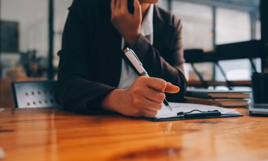 Ofiste dizüstü bilgisayarda çalışan Asyalı iş kadını masasında belgelerle mali raporu, iş planı yatırımını, mali analiz kavramını analiz etmeyi planlıyor.