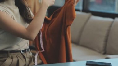 Modern atölyede yeni kıyafet koleksiyonu üzerinde çalışan profesyonel tasarımcı