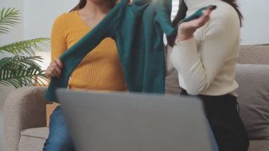 Genç Asyalı kadınlar ofiste alışveriş ve paketleme yapıyorlar..