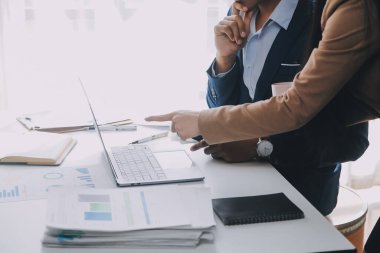 İş ekibi ile yeni başlangıç planı ve tartışma için proje bilgilerini dizüstü bilgisayar ve dijital tablet ile mali strateji bir modern iş salonda çalışıyor.