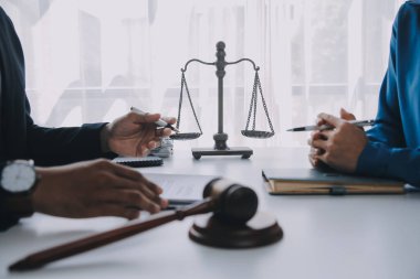 Adalet ve hukuk kavramı. Hukuk Müşaviri tokmak ve yasal hukuk veya yasal ile imzalanmış bir sözleşme istemciye sunar arka planda hukuk firmasında takım toplantısı