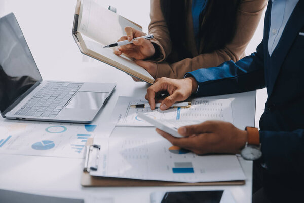 Business team working with new startup project plan and discussion information for financial strategy with laptop and digital tablet in a modern business lounge.