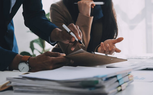 Business team working with new startup project plan and discussion information for financial strategy with laptop and digital tablet in a modern business lounge.
