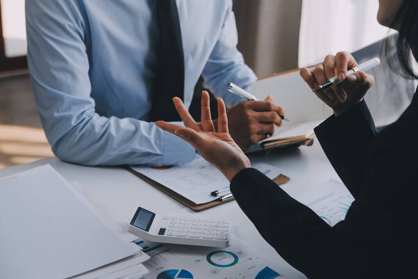Business team working with new startup project plan and discussion information for financial strategy with laptop and digital tablet in a modern business lounge.