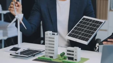 Çağdaş ofis ortamında çevre dostu yeni bir kompleks projesinde işbirliği yapan genç profesyonellerden oluşan bir ekip.