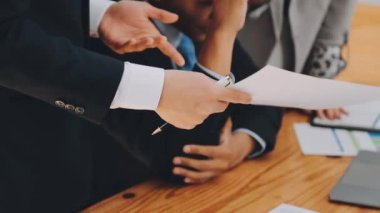 Bir grup sıradan giyinmiş Asyalı iş adamı ofiste fikirleri tartışıyor. Yaratıcı profesyoneller, yeni başarılı girişim projesinin önemli konularını tartışmak üzere toplantı masasında bir araya geldiler.