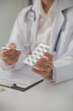 Healthcare service and pharmacy worker with customer at store counter for medication explanation. Pharmaceutical advice and opinion of pharmacist helping girl with medicine information.