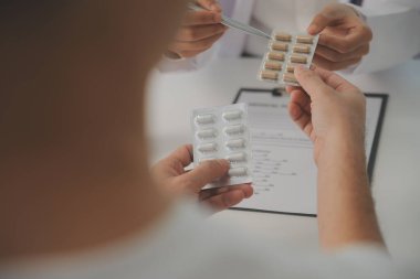 Healthcare service and pharmacy worker with customer at store counter for medication explanation. Pharmaceutical advice and opinion of pharmacist helping girl with medicine information.