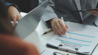 Bir takım ortamında finansal verileri ve pazarlama performans grafiklerini tartışan ve analiz eden iş uzmanları, kârlılığın artması için stratejik planlamaya odaklanıyorlar..