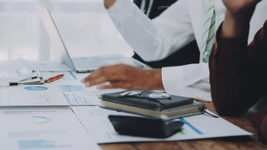 Genç girişimciler, iş ve finans kavramlarını somutlaştıran çağdaş bir ofiste birlikte çalışıyorlar..