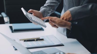 Şık bir ofis ortamında iş ve finans konularına odaklanan bir grup enerjik iş adamı