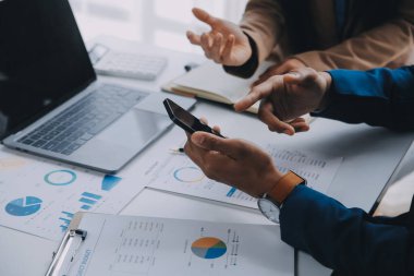 İş ekibi ile yeni başlangıç planı ve tartışma için proje bilgilerini dizüstü bilgisayar ve dijital tablet ile mali strateji bir modern iş salonda çalışıyor.