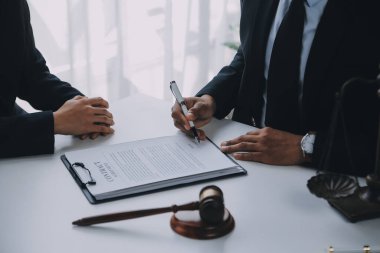 Adalet ve hukuk kavramı. Hukuk Müşaviri tokmak ve yasal hukuk veya yasal ile imzalanmış bir sözleşme istemciye sunar arka planda hukuk firmasında takım toplantısı