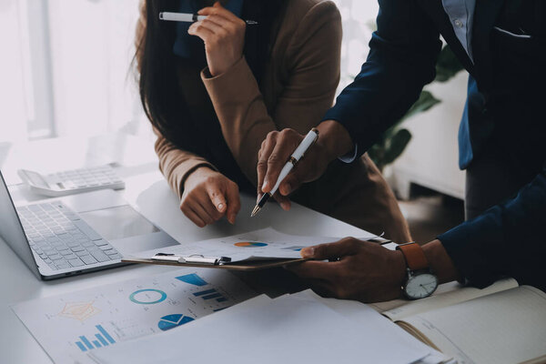 Business team working with new startup project plan and discussion information for financial strategy with laptop and digital tablet in a modern business lounge.