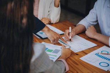 İş ekibi ile yeni başlangıç planı ve tartışma için proje bilgilerini dizüstü bilgisayar ve dijital tablet ile mali strateji bir modern iş salonda çalışıyor.