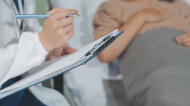 Yakın plan - bir hastanın elini tutan ve tedavi için reçete yazan doktorlar. tıbbi konsept